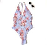 A classic one-piece swimsuit with blue and red print